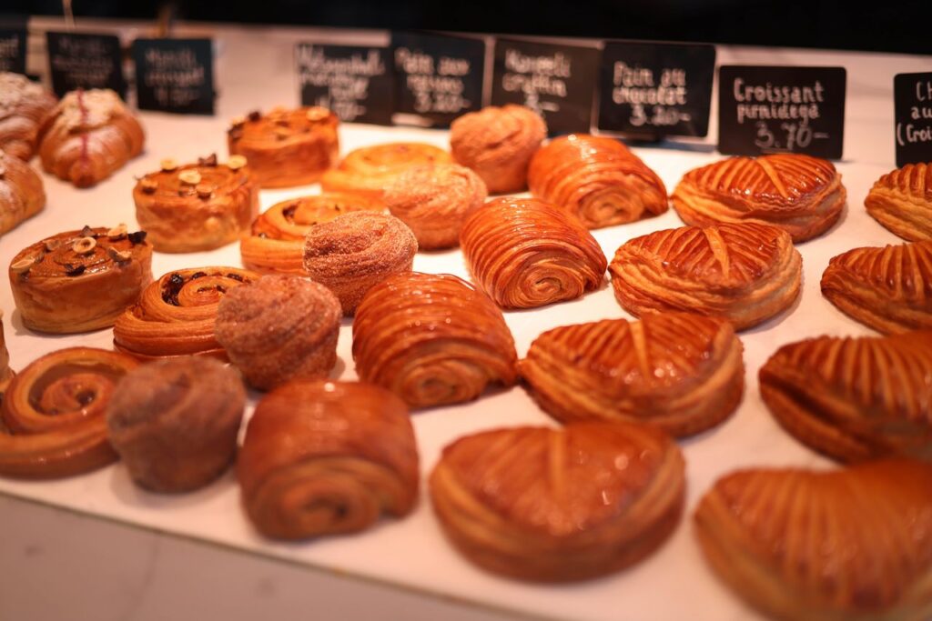 A tempting variety of pastries beautifully arranged in a bakery display.